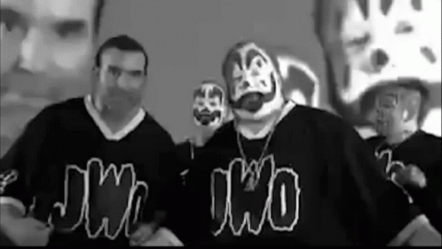 A Group Of Men Wearing Clown Masks And Shirts Are Standing Next To Each Other In A Room . GIF