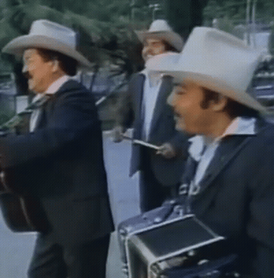 A Group Of Men Wearing Cowboy Hats And Suits Are Playing Instruments GIF
