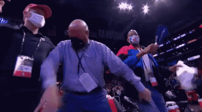 A Group Of Men Wearing Face Masks Are Standing In A Stadium . GIF