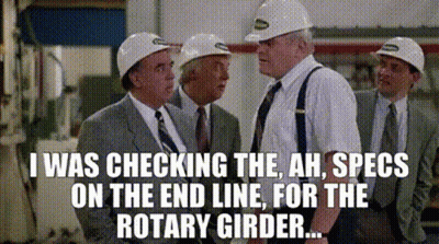 A Group Of Men Wearing Hard Hats And Suits Are Standing Next To Each Other . GIF