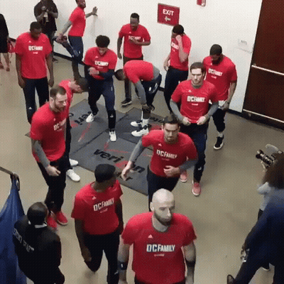 A Group Of Men Wearing Red Shirts That Say Dc Family On Them GIF