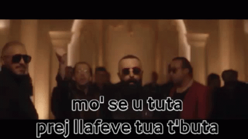 A Group Of Men Wearing Sunglasses And A Beard Are Standing In A Room . GIF
