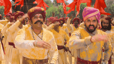 A Group Of Men Wearing Turbans And Yellow Shirts Are Dancing GIF