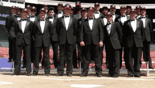 A Group Of Men Wearing Tuxedos And Bow Ties Pose For A Photo GIF