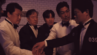 A Group Of Men Wearing Tuxedos And Bow Ties With The Number 036 On Their Chests GIF