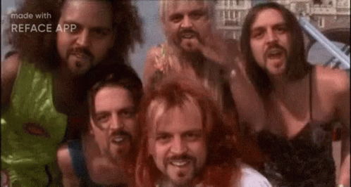 A Group Of Men With Beards Are Posing For A Picture . GIF