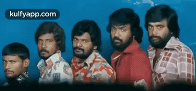 A Group Of Men With Beards Are Standing Next To Each Other In A Line . GIF
