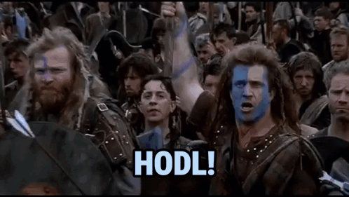 A Group Of Men With Blue And White Paint On Their Faces Are Standing In A Crowd With Their Arms In The Air . GIF