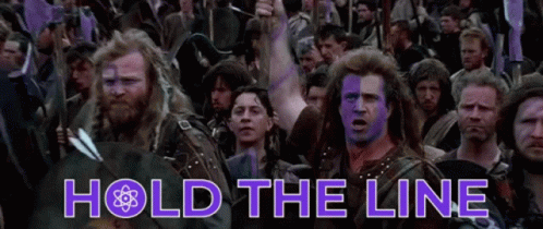 A Group Of Men With Purple Paint On Their Faces Are Standing In A Crowd With The Words Hold The Line Above Them GIF