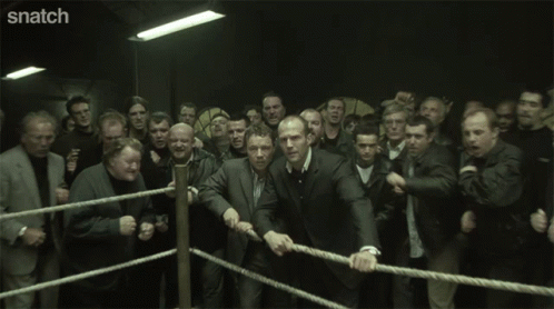 A Group Of Men With Their Eyes Closed And Snatch Written On The Bottom Right GIF