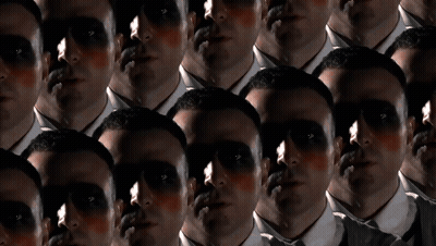 A Group Of Men With Their Faces Painted Black GIF