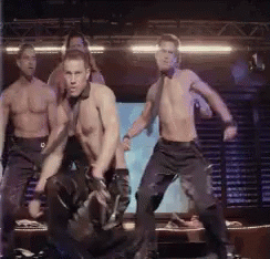 A Group Of Men Without Shirts Are Dancing On A Stage GIF