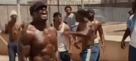 A Group Of Men Without Shirts Are Standing Next To Each Other And Laughing . GIF