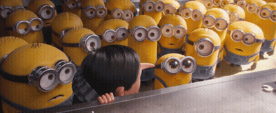 A Group Of Minions Are Gathered Around A Boy GIF