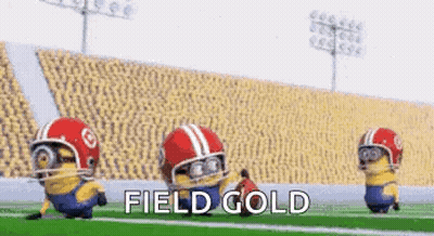 A Group Of Minions Are Playing Football On A Field . GIF