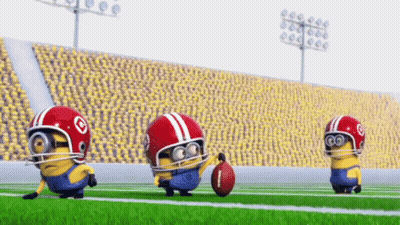 A Group Of Minions Are Playing Football On A Field GIF
