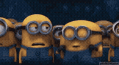 A Group Of Minions Are Standing Next To Each Other With Their Mouths Wide Open . GIF