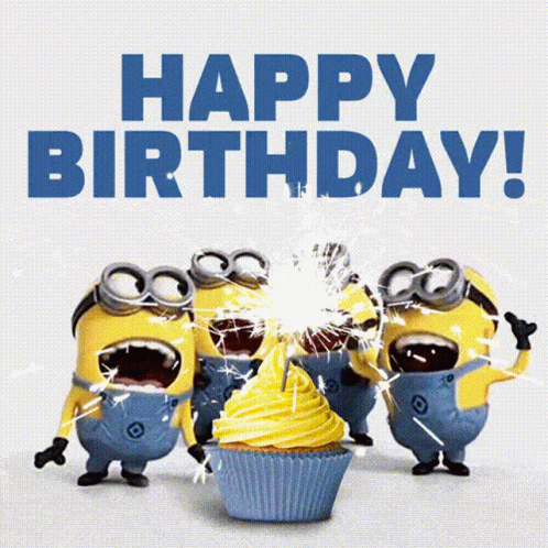 A Group Of Minions Celebrate A Birthday With A Cupcake And Sparklers GIF