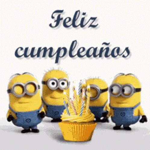 A Group Of Minions Standing Around A Cupcake With Candles GIF