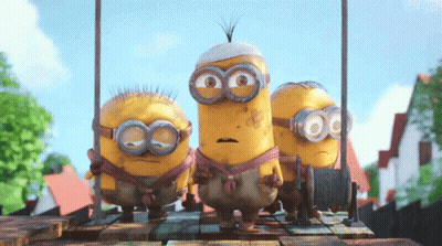 A Group Of Minions Standing On A Wooden Platform GIF