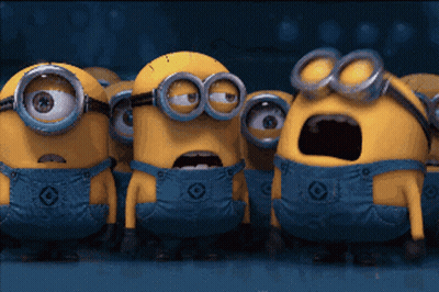 A Group Of Minions Wearing Blue Overalls And Goggles Are Standing Together GIF