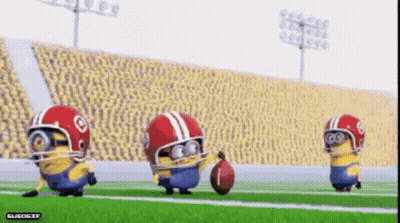 A Group Of Minions Wearing Football Helmets Are Playing A Game Of Football GIF