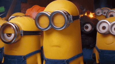 A Group Of Minions Wearing Goggles And Overalls Are Standing Next To Each Other GIF