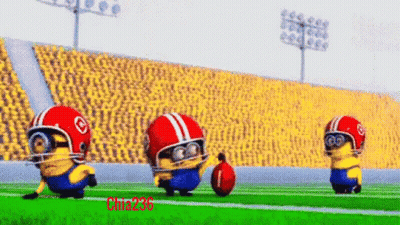 A Group Of Minions Wearing Helmets And Goggles Are Playing Football On A Field GIF