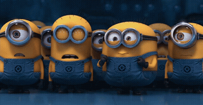 A Group Of Minions Wearing Overalls And Goggles Are Standing In A Line GIF