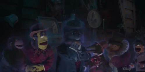 A Group Of Muppets Are Standing In A Dark Room With A Disney+ Logo In The Corner GIF
