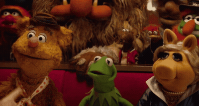 A Group Of Muppets Including Kermit And Miss Piggy Are Sitting Together GIF