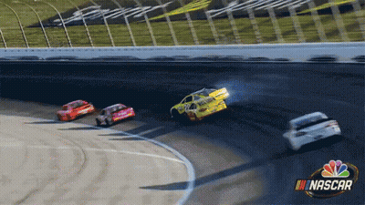 A Group Of Nascar Cars Are Racing Around A Track GIF