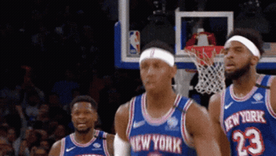 A Group Of New York Basketball Players Are Standing In Front Of A Net GIF