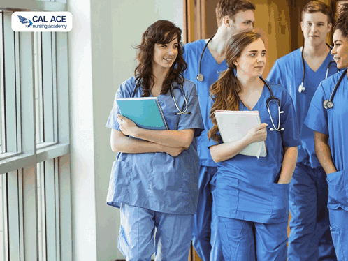 A Group Of Nurses Are Walking Down A Hallway With A Cal Ace Nursing Academy Logo Behind Them GIF