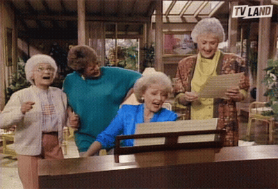 A Group Of Old Women Singing In Front Of A Tv Land Sign GIF