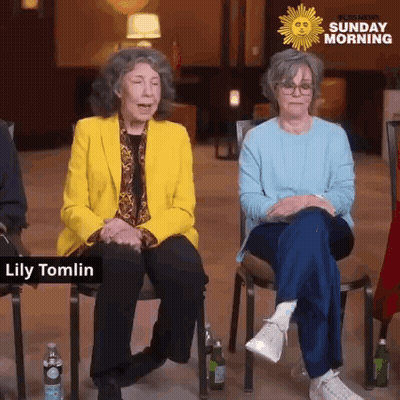 A Group Of Older Women Are Sitting In Chairs In Front Of A Sunday Morning Logo . GIF