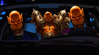 A Group Of Orcs Are Sitting In A Car With A Man In A Suit GIF