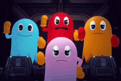A Group Of Pac Man Ghosts Standing Next To Each Other In A Dark Room GIF