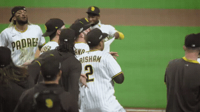 A Group Of Padres Baseball Players Are Standing On A Field GIF