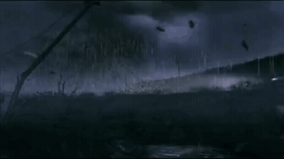 A Group Of Parachutes Are Flying In The Sky Over A Field With Telephone Wires . GIF