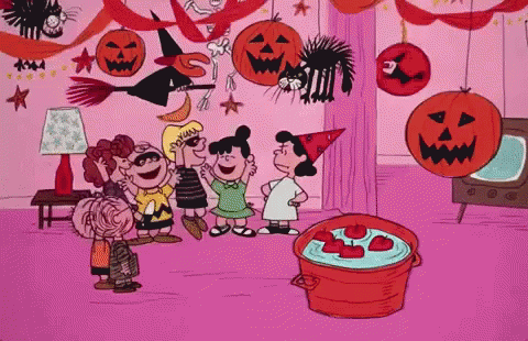 A Group Of Peanuts Characters Are Standing Around A Pot Of Apples GIF
