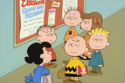 A Group Of Peanuts Characters Are Standing In Front Of A Bulletin Board That Says Election Student Body President GIF