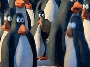 A Group Of Penguins Are Standing In A Line With Their Eyes Closed GIF