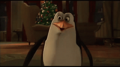 A Group Of Penguins Standing Next To Each Other With Their Beaks Open GIF