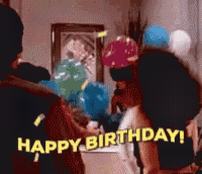 A Group Of People Are Celebrating A Birthday With Balloons And Confetti GIF