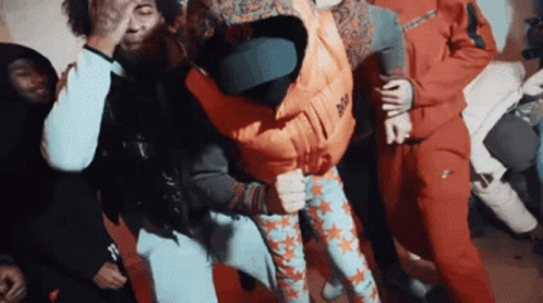 A Group Of People Are Dancing And One Of Them Is Wearing A Vest That Says Nike GIF