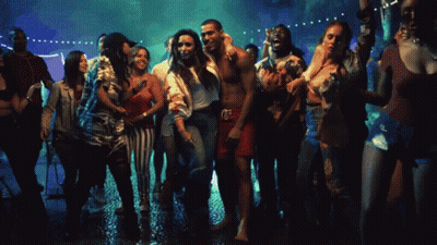 A Group Of People Are Dancing At A Party And One Of Them Is Wearing A Shirt That Says ' Calvin Klein ' GIF