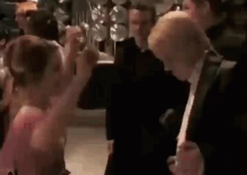 A Group Of People Are Dancing At A Party In A Room . GIF