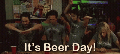 A Group Of People Are Dancing In A Bar And The Words It 'S Beer Day Are Above Them GIF