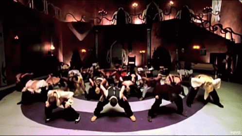 A Group Of People Are Dancing In A Circle With The Word Vevo On The Bottom Right GIF
